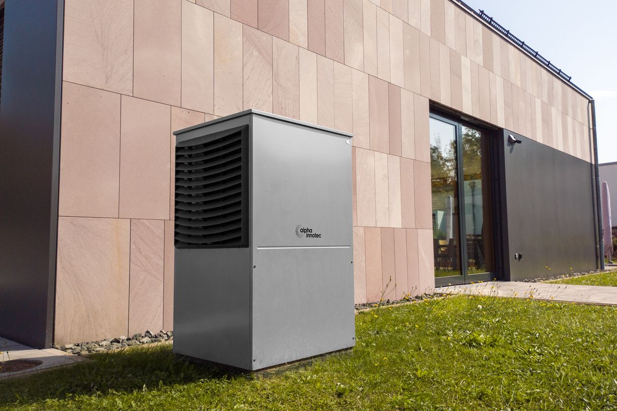 Air-source heat pump beside a home