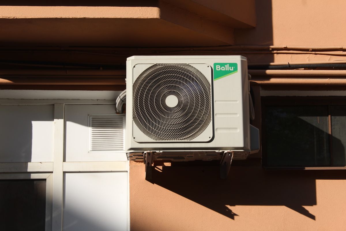 Air conditioner condenser unit outside a home